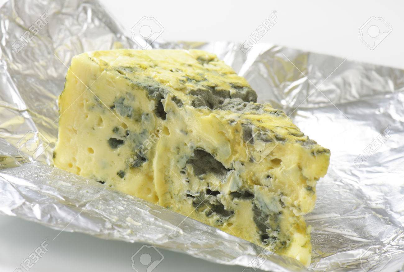 wedge of french blue cheese on foil stock photo picture and royalty
