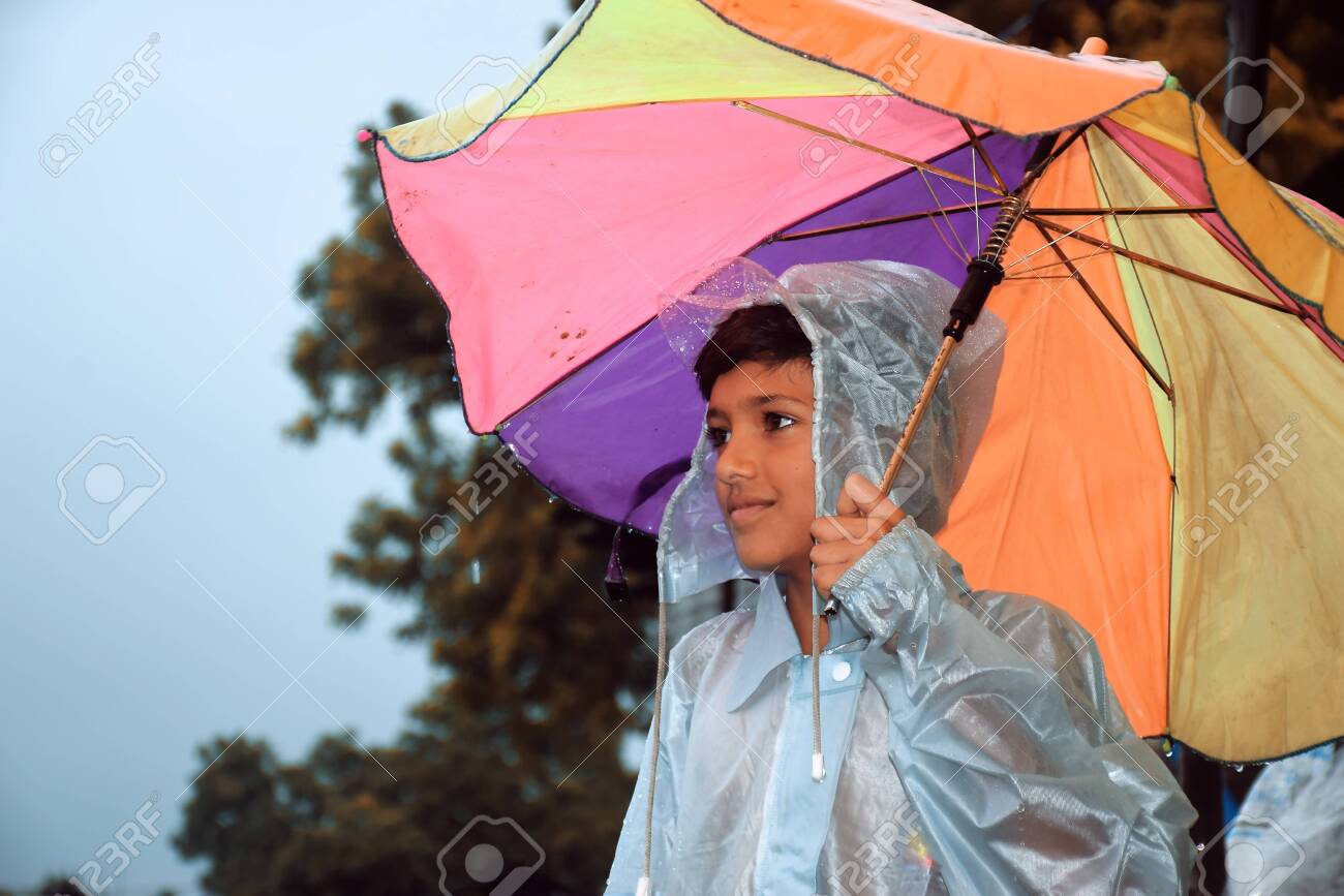 A Indian Boy Looking The Other Way, Wearing Rainbows In Wet Water,.. Stock  Photo, Picture And Royalty Free Image. Image 131825433.