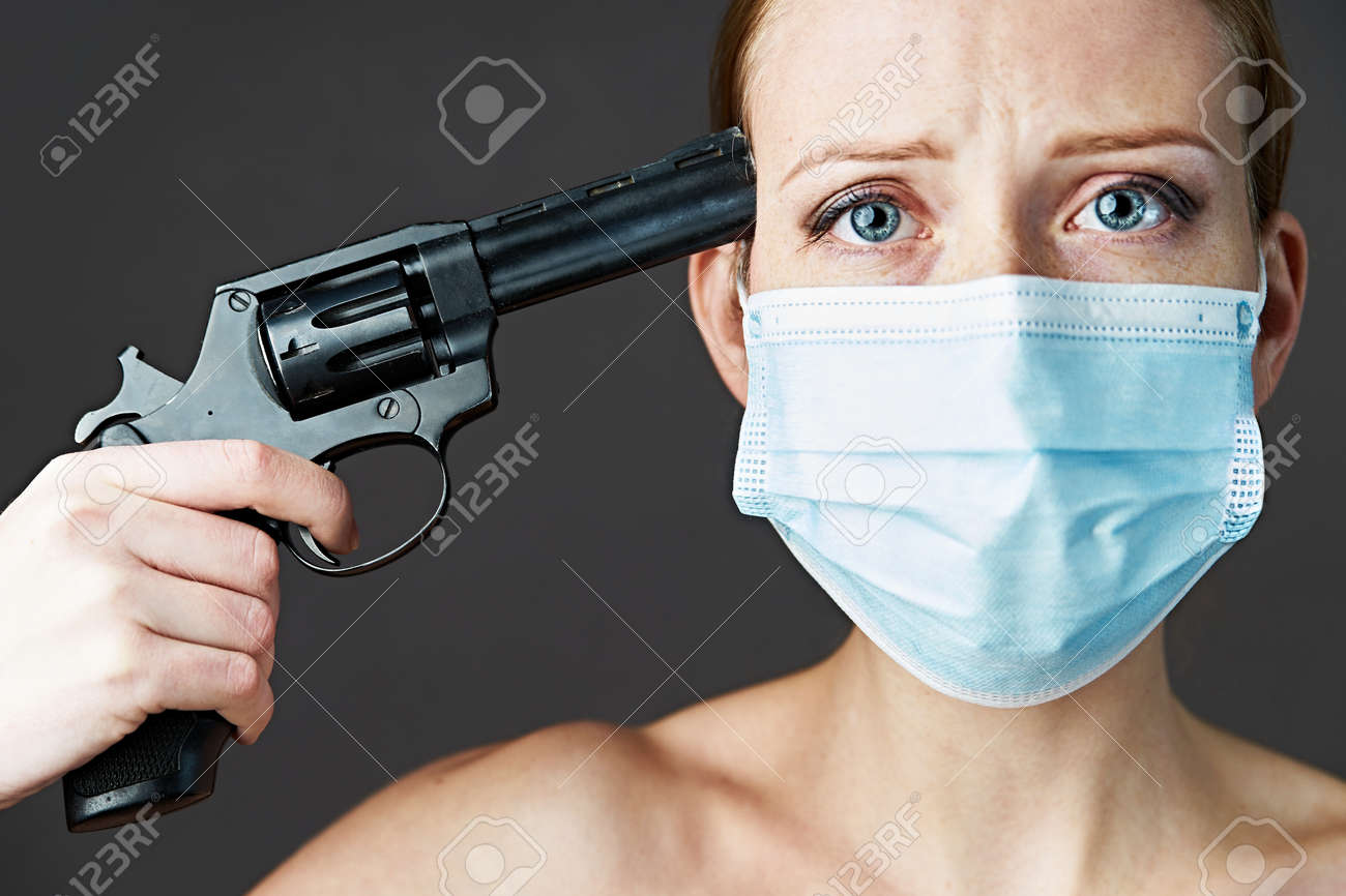 Violence in family. Girl with a revolver in her hands, stands with her back turned to the camera - 159316743 Violence in family. Girl with a revolver in her hands, stands with her back turned to the camera - 159316743