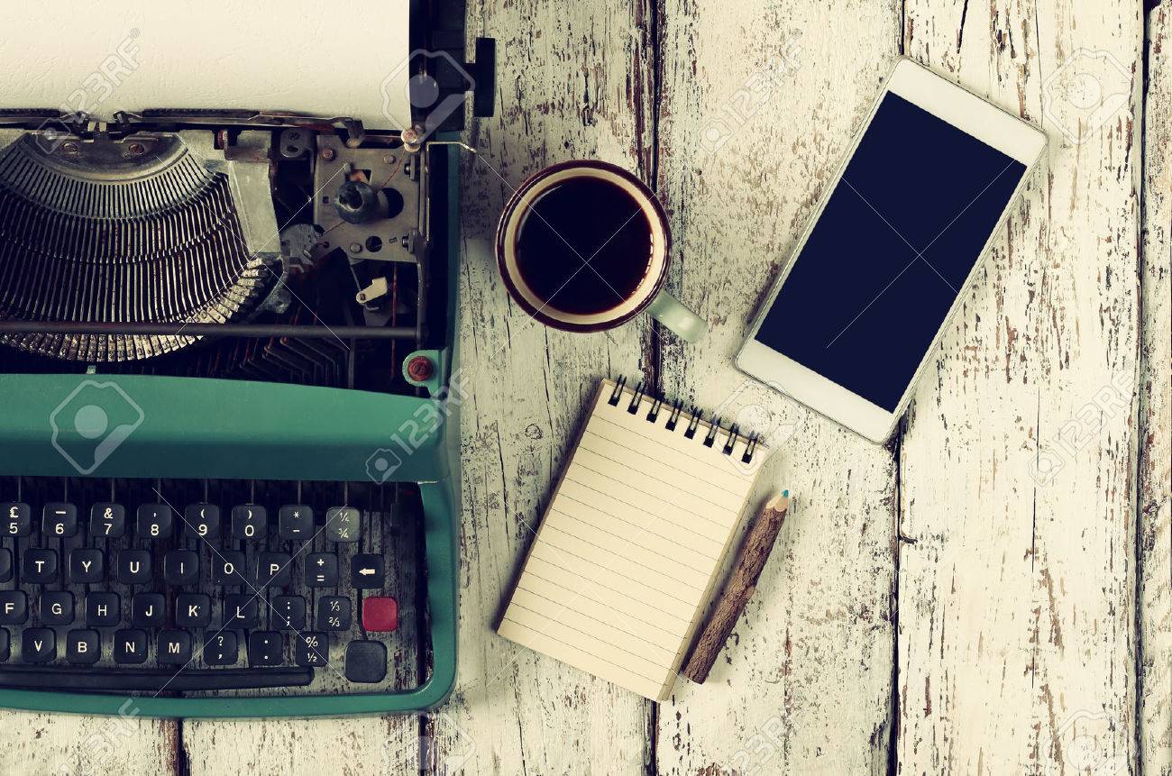 retro filtered image of vintage typewriter, blank notebook, cup of coffee and smartphone on wooden table - 51657494 retro filtered image of vintage typewriter, blank notebook, cup of coffee and smartphone on wooden table - 51657494