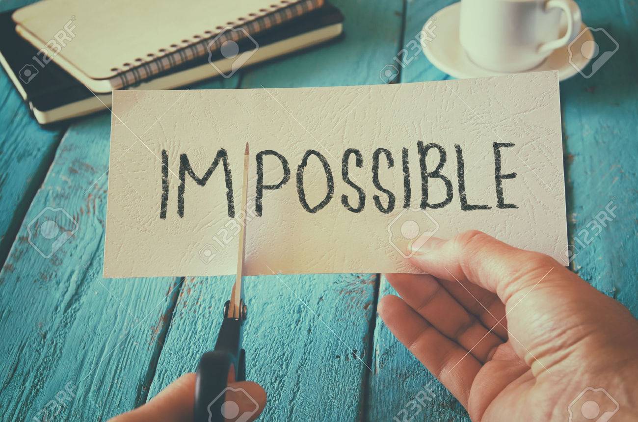 man hand holding card with the text impossible, cutting the word im so it written possible. success and challenge concept. retro style image - 53662787 man hand holding card with the text impossible, cutting the word im so it written possible. success and challenge concept. retro style image - 53662787