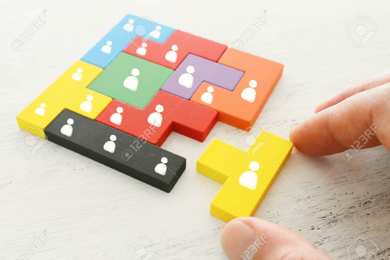business concept image of tangram puzzle blocks with people icons over wooden table ,human resources and management concept - 128865675 business concept image of tangram puzzle blocks with people icons over wooden table ,human resources and management concept - 128865675