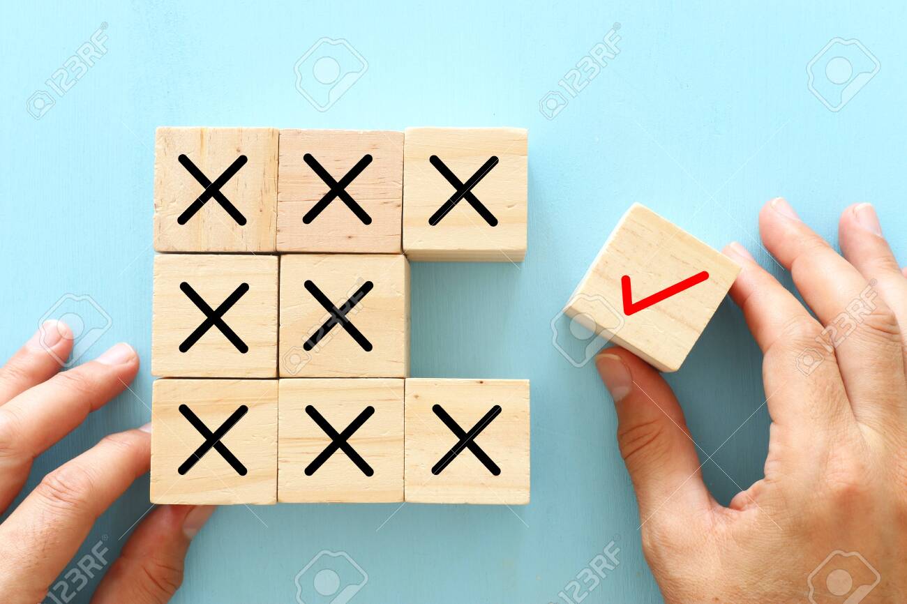 A hand chooses a cube with check mark symbol instead of cubes with cross sign. An idea of positive thinking and change of mind - 135242450 A hand chooses a cube with check mark symbol instead of cubes with cross sign. An idea of positive thinking and change of mind - 135242450