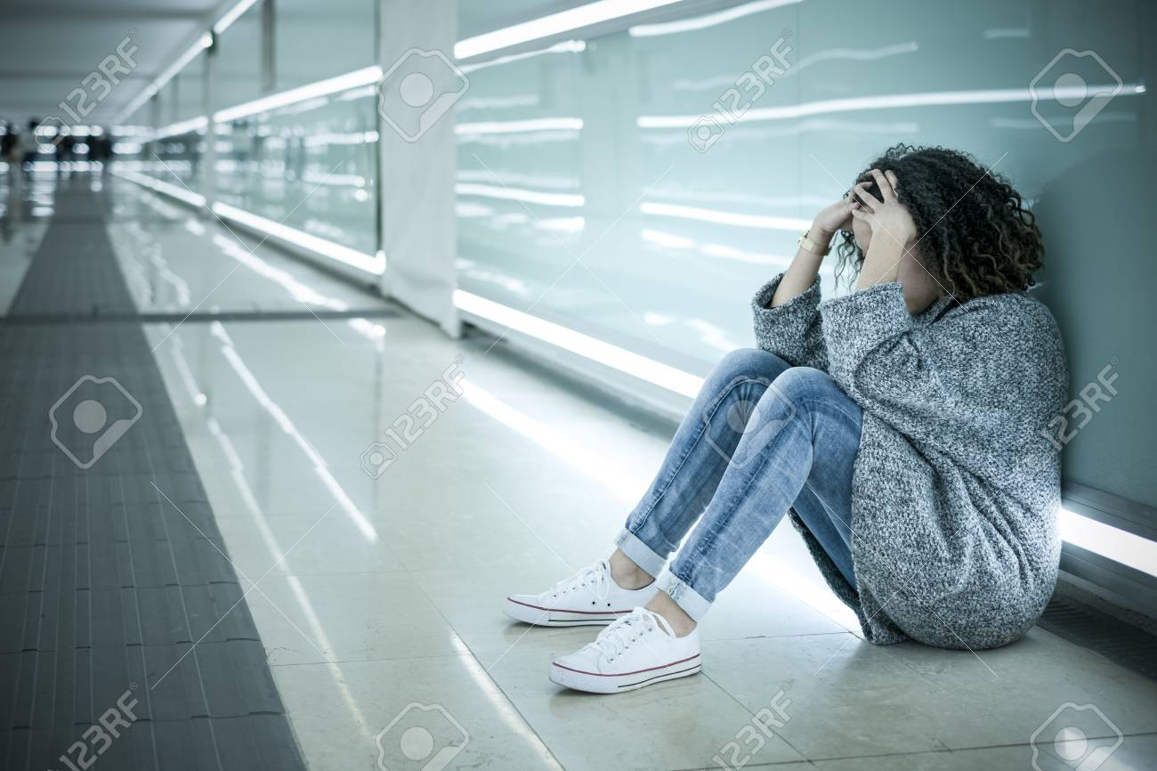 Lonely And Sad Girl Seated On The Ground Alone Stock Photo ...