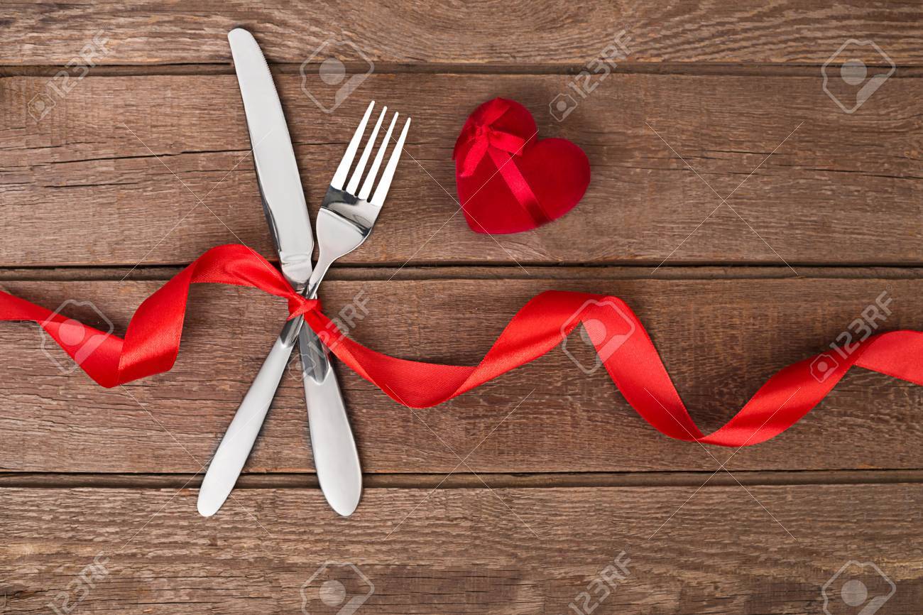Dinner Table Background valentines day dinner table setting with red ribbon, knife and Dinner Table Background valentines day dinner table setting with red ribbon, knife and