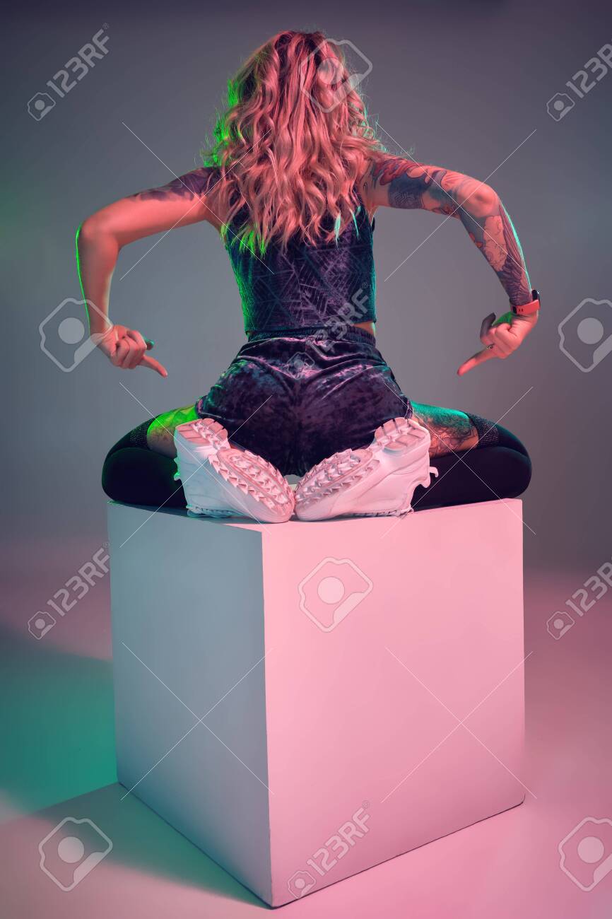 Young Fitness Blonde Woman Wearing Blue Velour Booty Shorts Posing