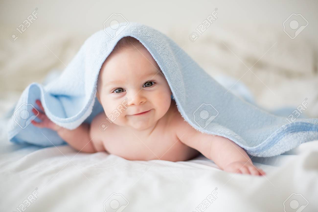 Cute Little Baby Boy, Relaxing In Bed After Bath, Smiling Happily ...