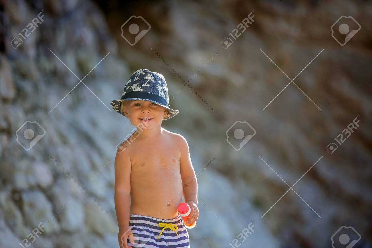 Beach Portrait Of Adorable Cute Toddler Boy With Long Hair Casual
