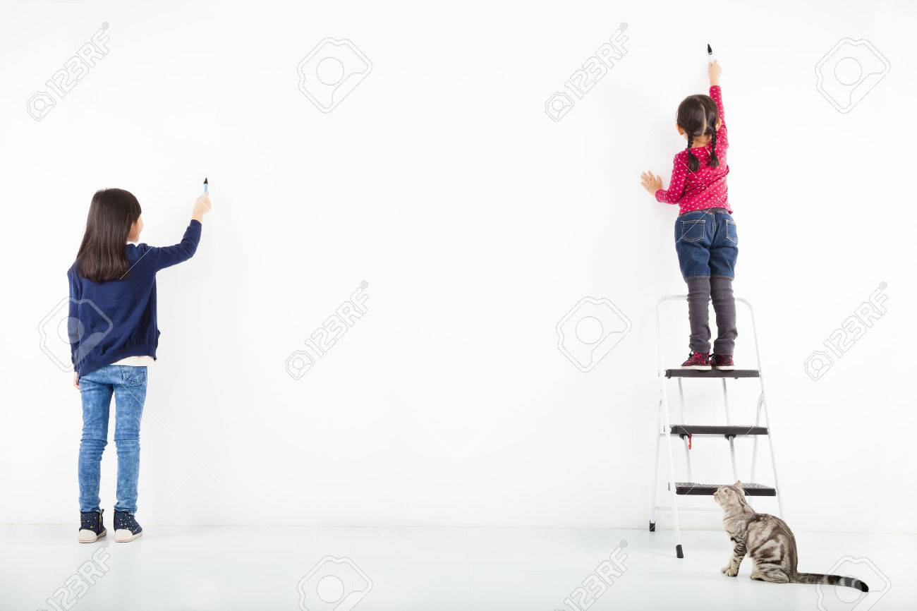 Two Kids Drawing On The Blank White Wall Stock Photo Picture And Royalty Free Image Image 23184562