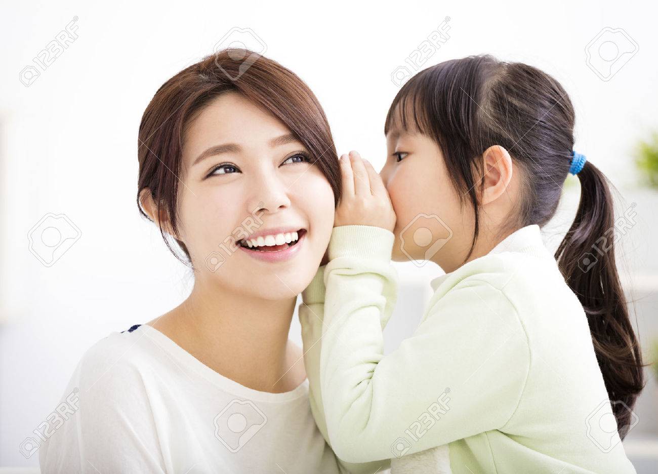 mother and daughter whispering gossip - 52256008 mother and daughter whispering gossip - 52256008