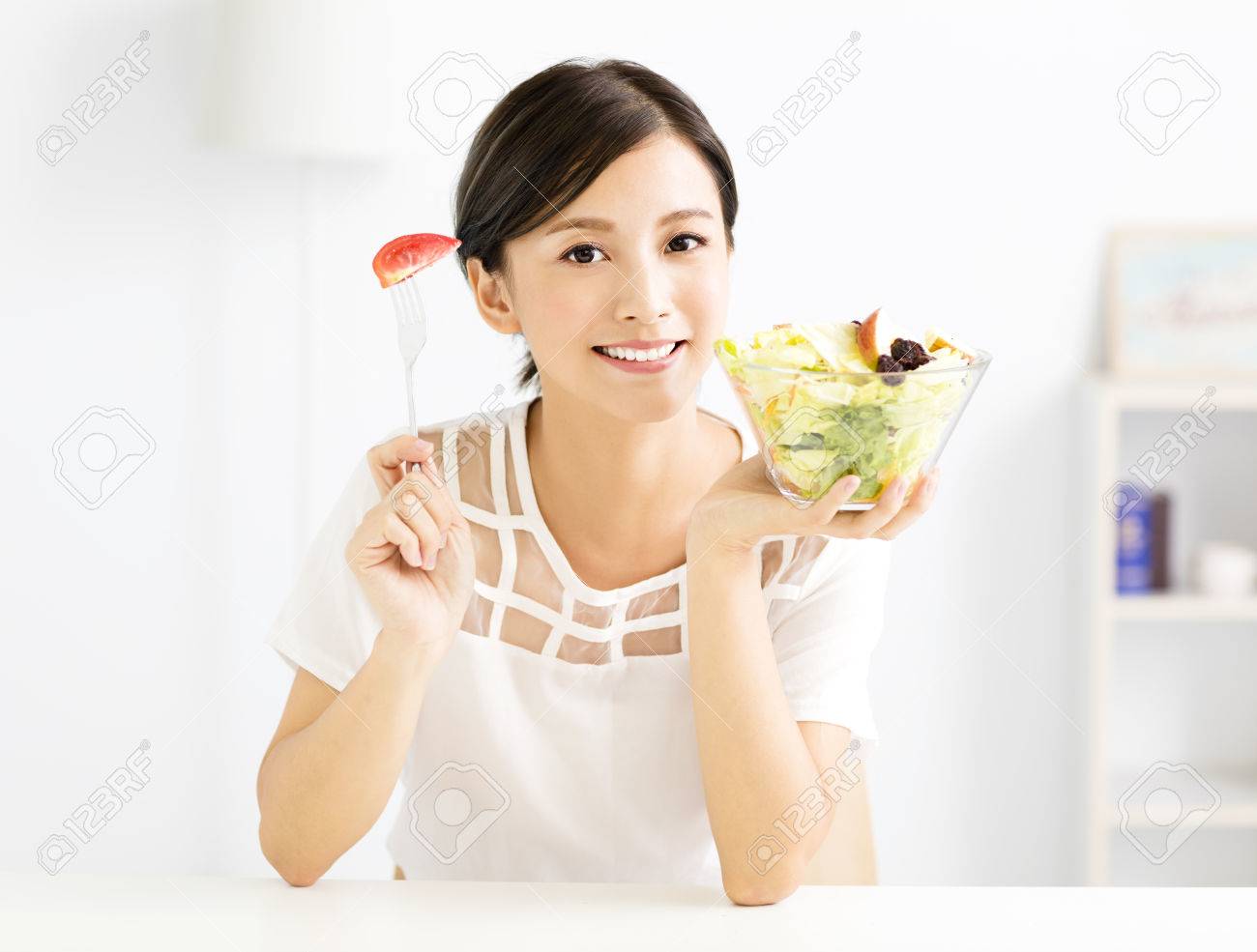 beautiful young woman eating healthy food - 63240222 beautiful young woman eating healthy food - 63240222