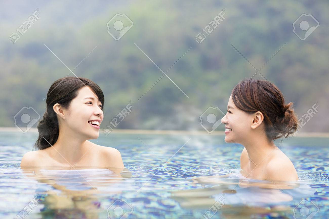 happy young woman relaxing in hot springs - 66159571 happy young woman relaxing in hot springs - 66159571