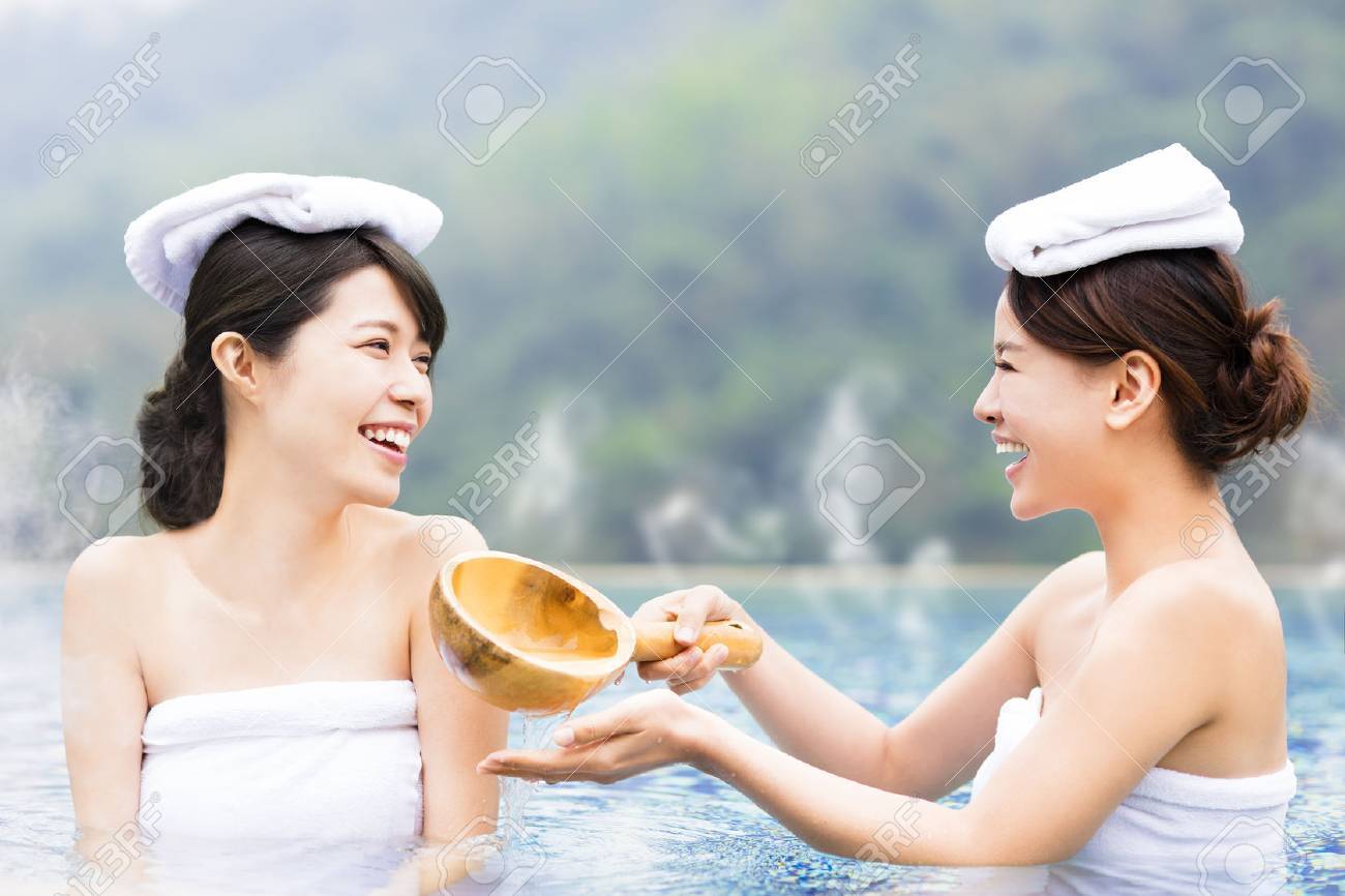 happy young woman relaxing in hot springs - 66539048 happy young woman relaxing in hot springs - 66539048