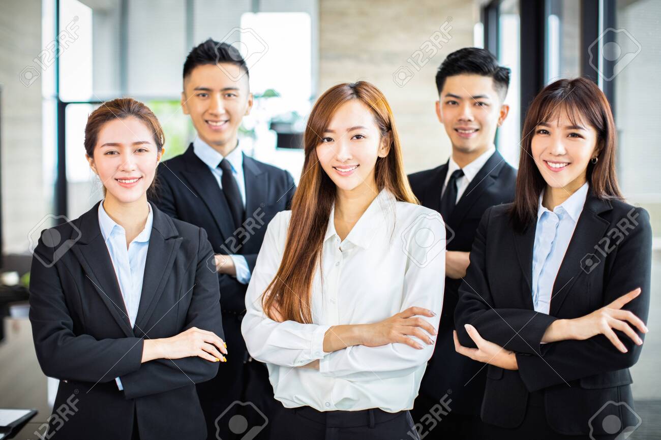 confident asian business team stands in office - 127105515 confident asian business team stands in office - 127105515