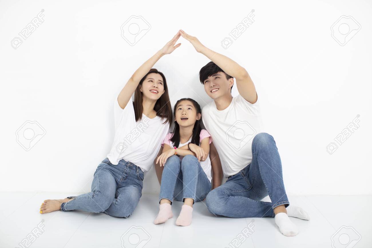 happy young family sitting on floor with home concept - 129608025 happy young family sitting on floor with home concept - 129608025
