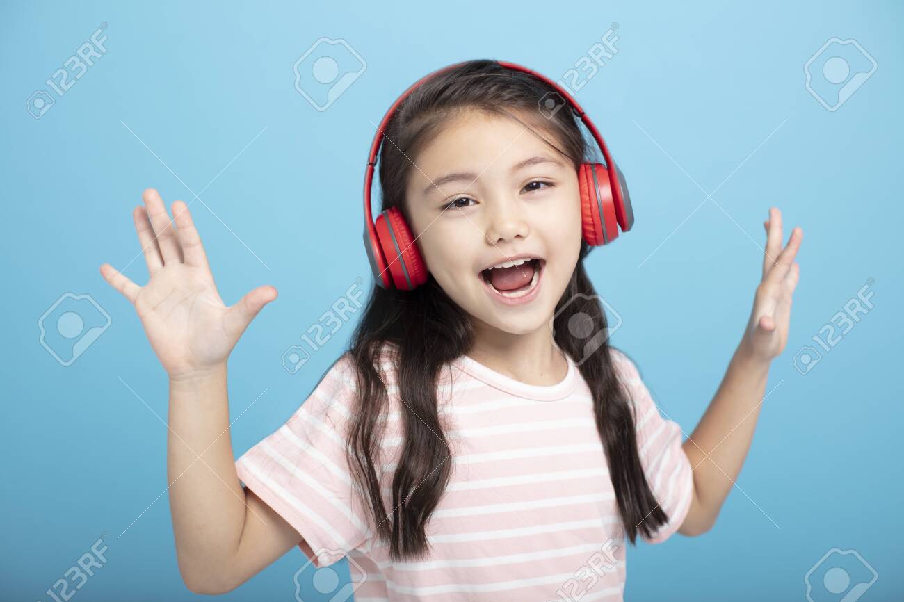 happy little girl with headphones listening and singing song - 133209416 happy little girl with headphones listening and singing song - 133209416