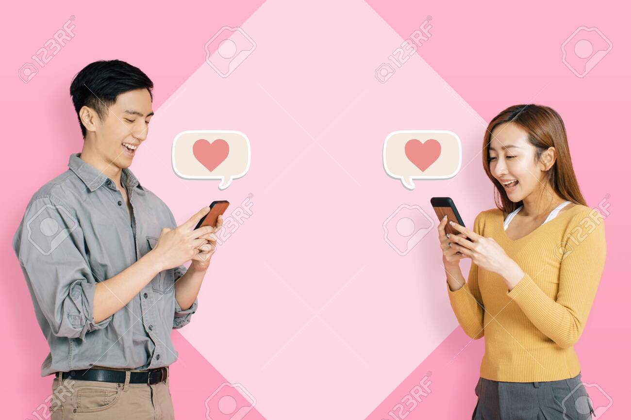 Young happy couple using mobile app to connect and instant messaging - 134719667 Young happy couple using mobile app to connect and instant messaging - 134719667