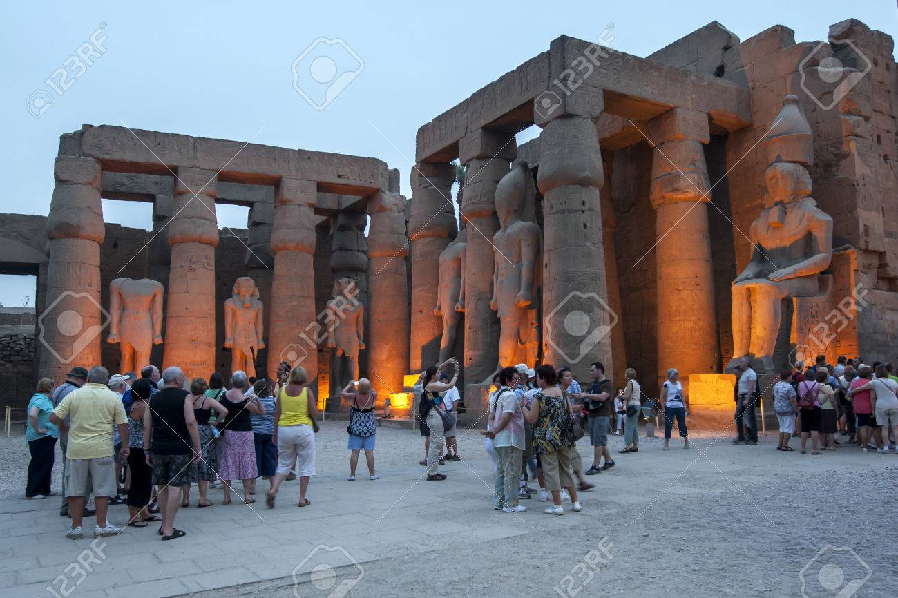 the sun sets over the courtyard of ramesses ll at the luxor temple