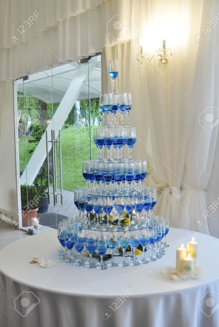blue champagne glasses pyramid wedding table arrangement stock photo