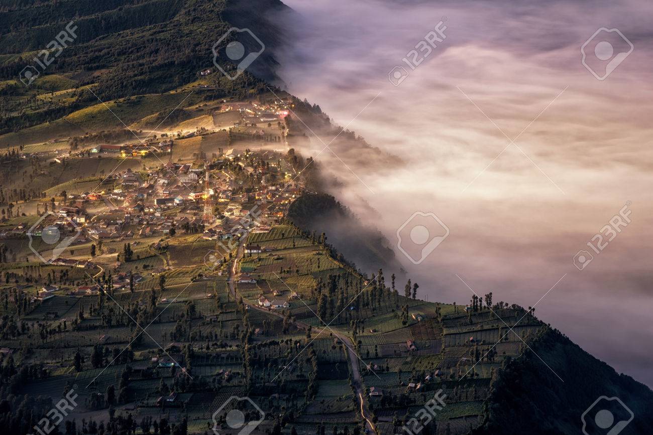 touch of morning light on fog and mist at cemoro lawang village