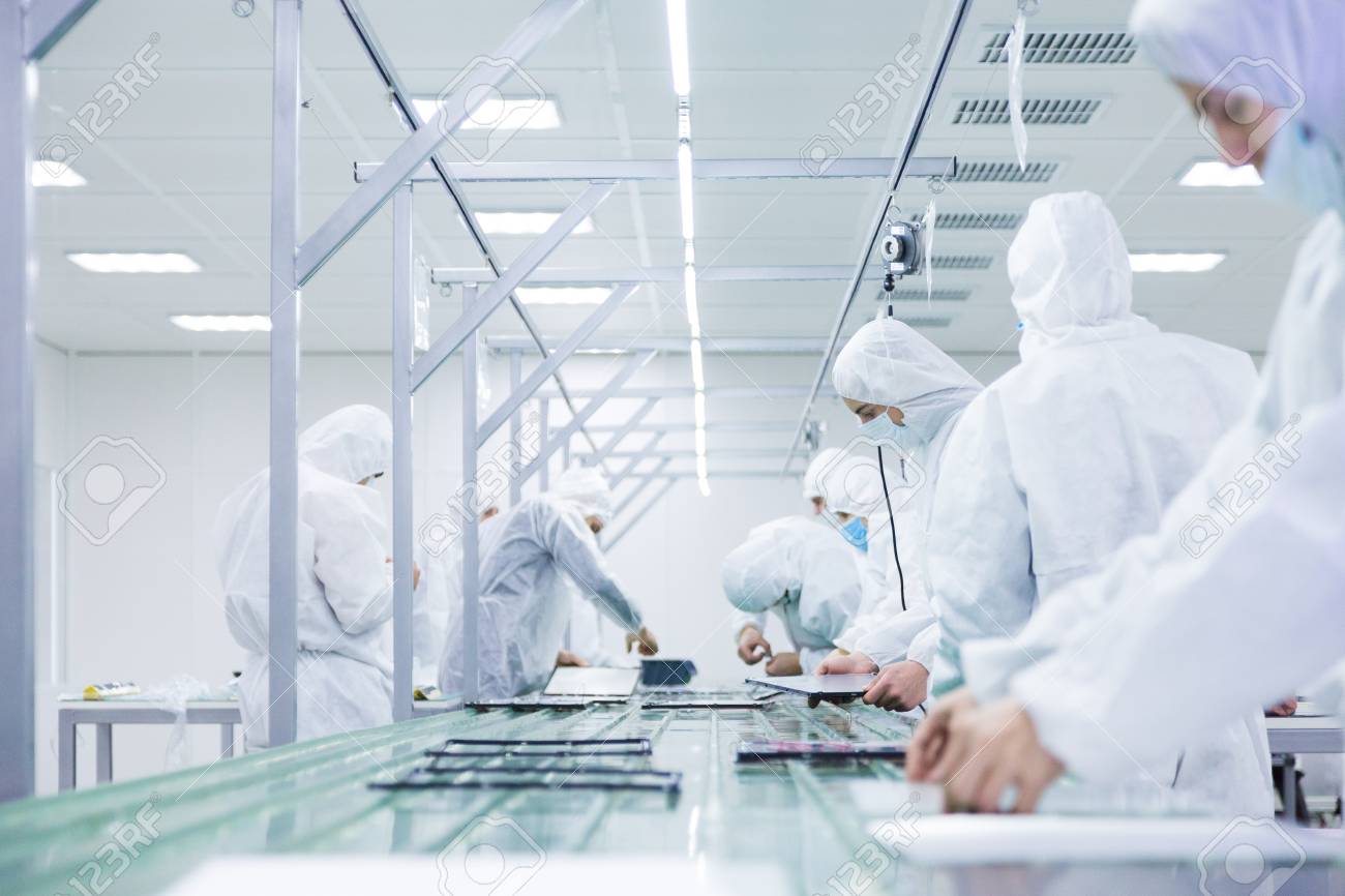 factory workers in white lab suits and face masks, producing tv sets on a green assembly line with some modern equipment - 91281334 factory workers in white lab suits and face masks, producing tv sets on a green assembly line with some modern equipment - 91281334