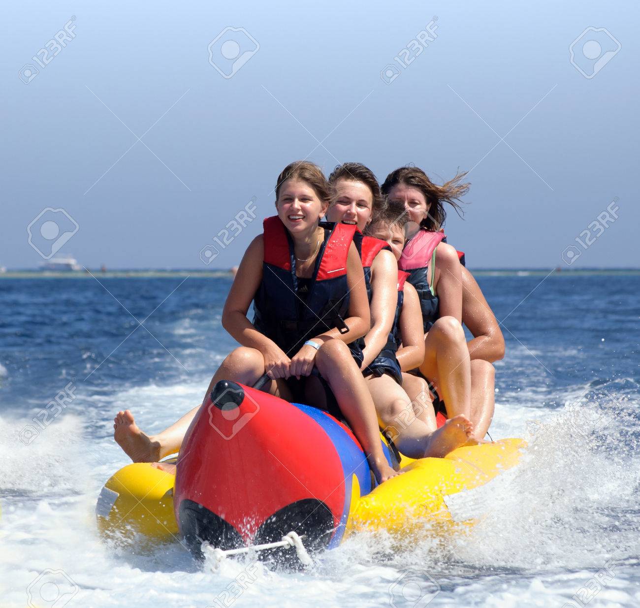 happy people having fun on banana boat on the red sea - 66701524 happy people having fun on banana boat on the red sea - 66701524