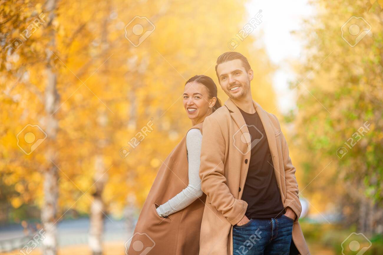 Happy family walking in autumn park on sunny fall day - 155228496 Happy family walking in autumn park on sunny fall day - 155228496