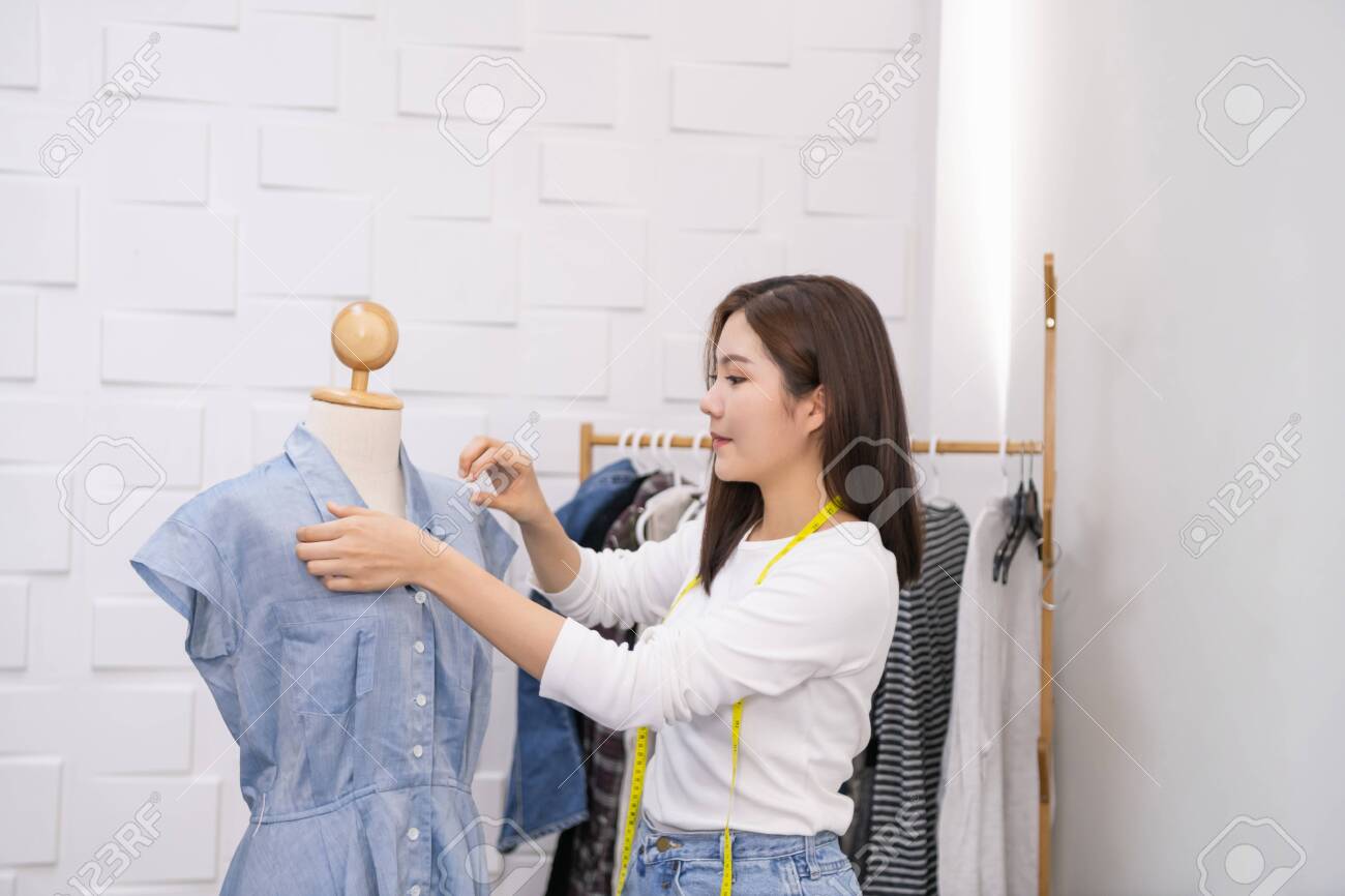 Designer concept. The dressmaker is designing an evening dress in the room. The tailor is working at his best. - 123017322 Designer concept. The dressmaker is designing an evening dress in the room. The tailor is working at his best. - 123017322