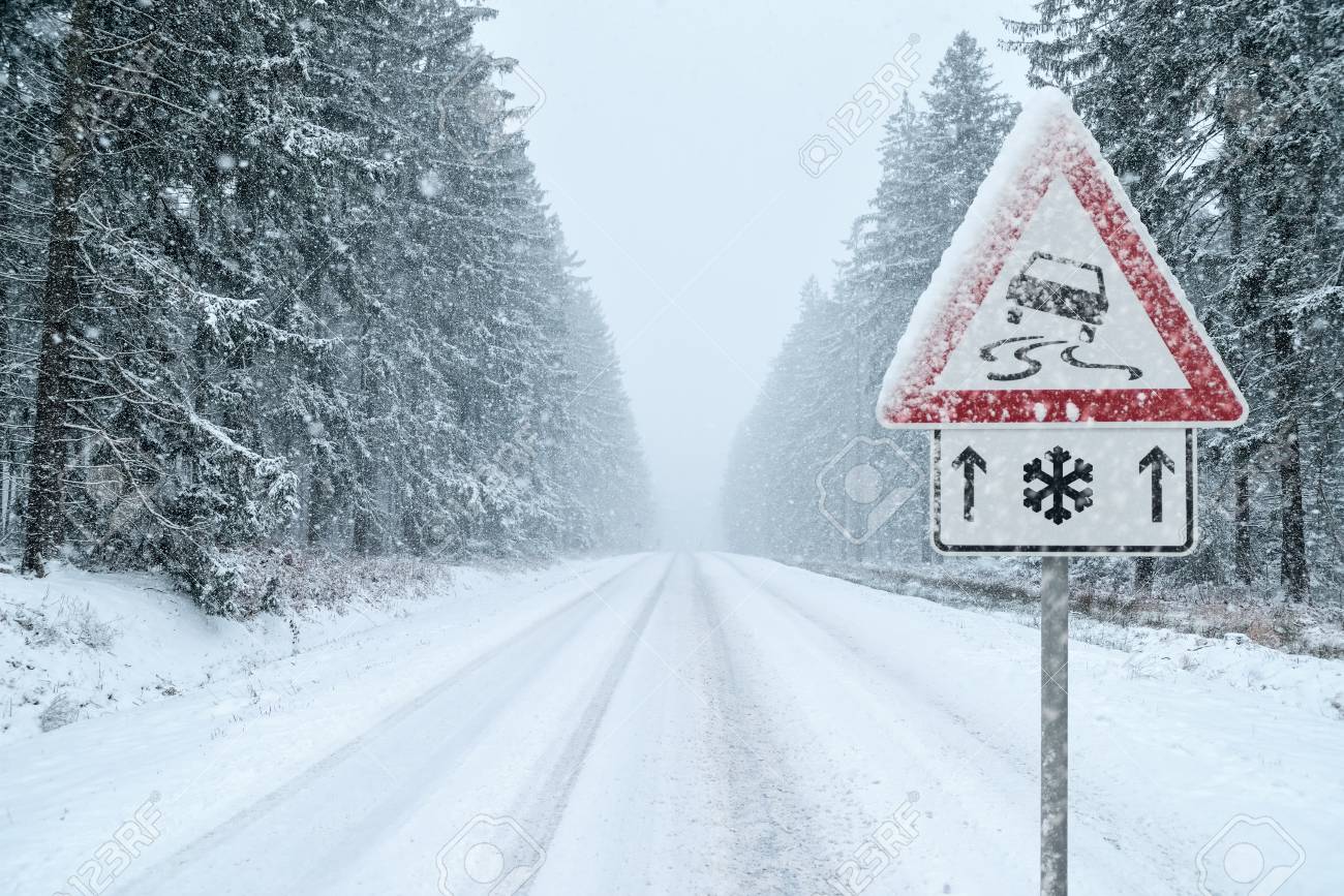Winter Driving - Snowy Road with Warning Sign - 113081644 Winter Driving - Snowy Road with Warning Sign - 113081644