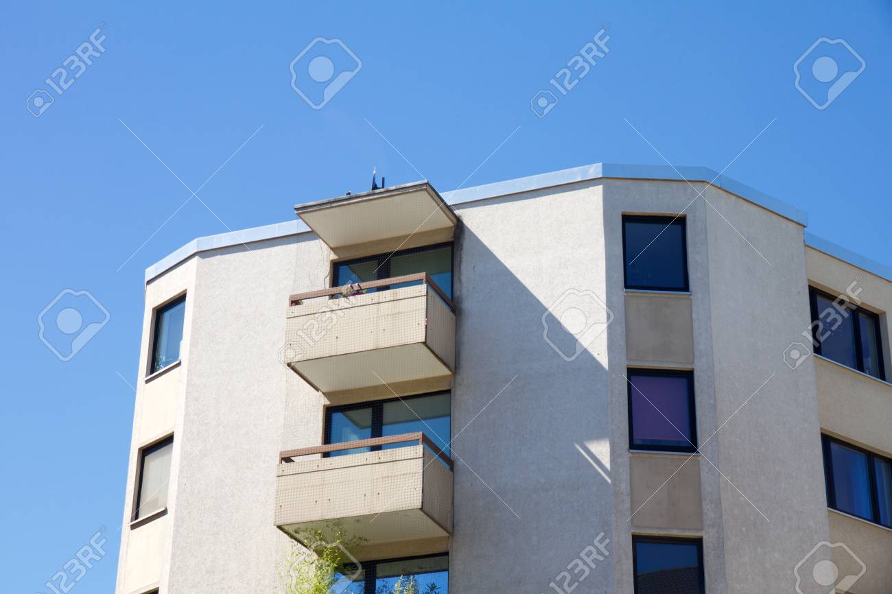 View on apartment building with balcony against a blue sky - 79149723 View on apartment building with balcony against a blue sky - 79149723