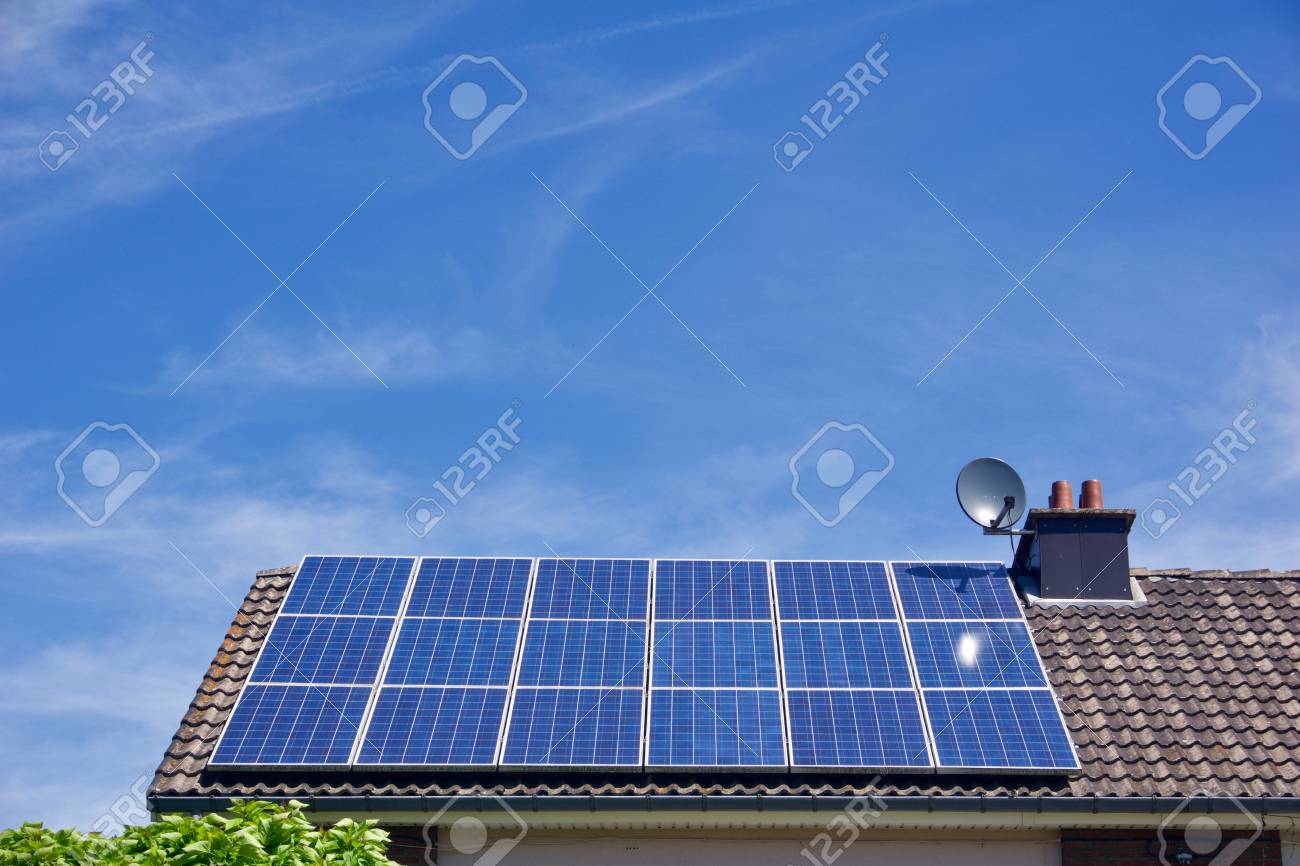 Photovoltaic panels on the roof of a residential building with copyspace - 85551834 Photovoltaic panels on the roof of a residential building with copyspace - 85551834
