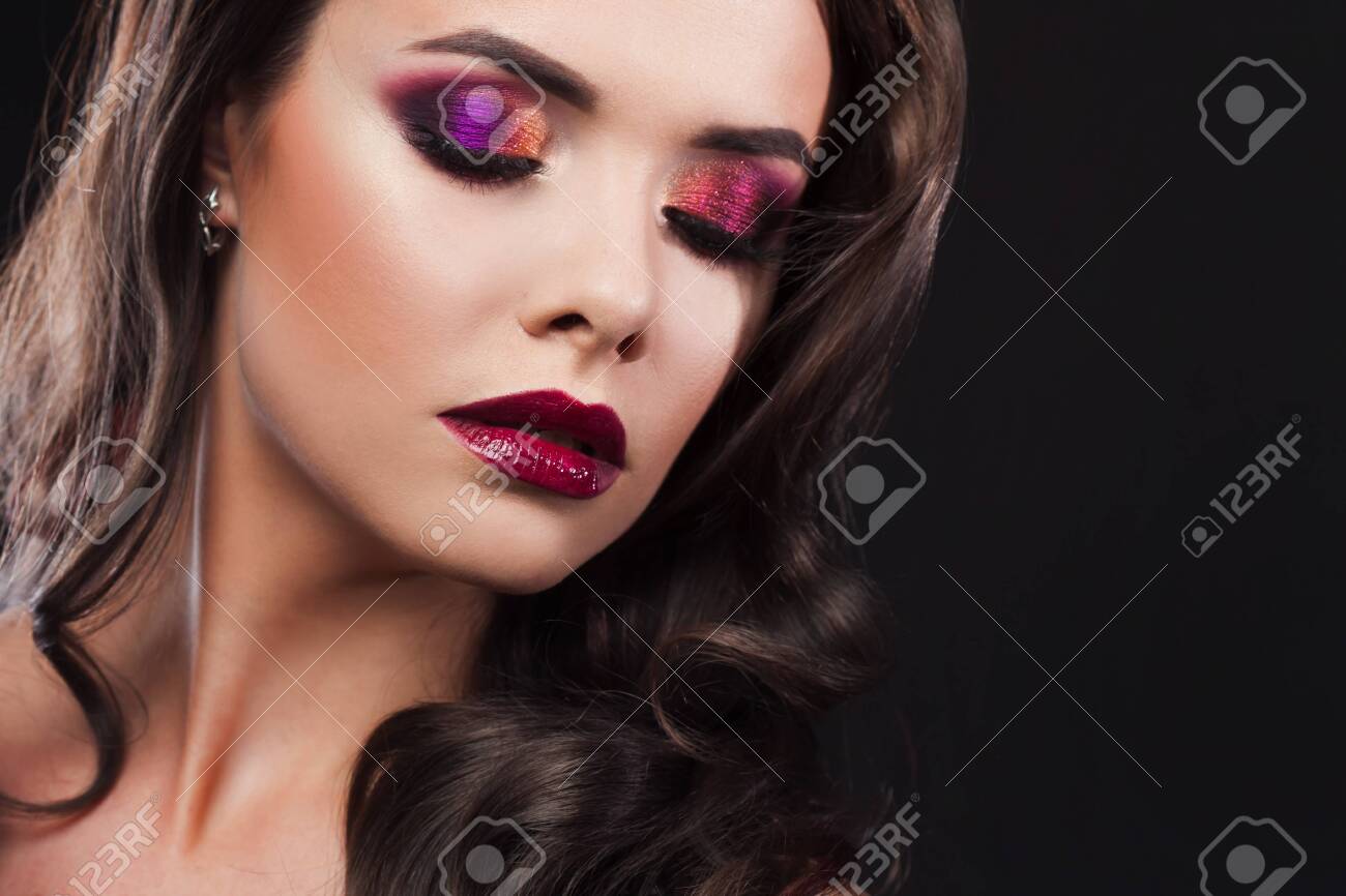 Gorgeous young brunette in a chic evening look. Scarlet lips and eye shadow, wave hair styling - 145577860 Gorgeous young brunette in a chic evening look. Scarlet lips and eye shadow, wave hair styling - 145577860