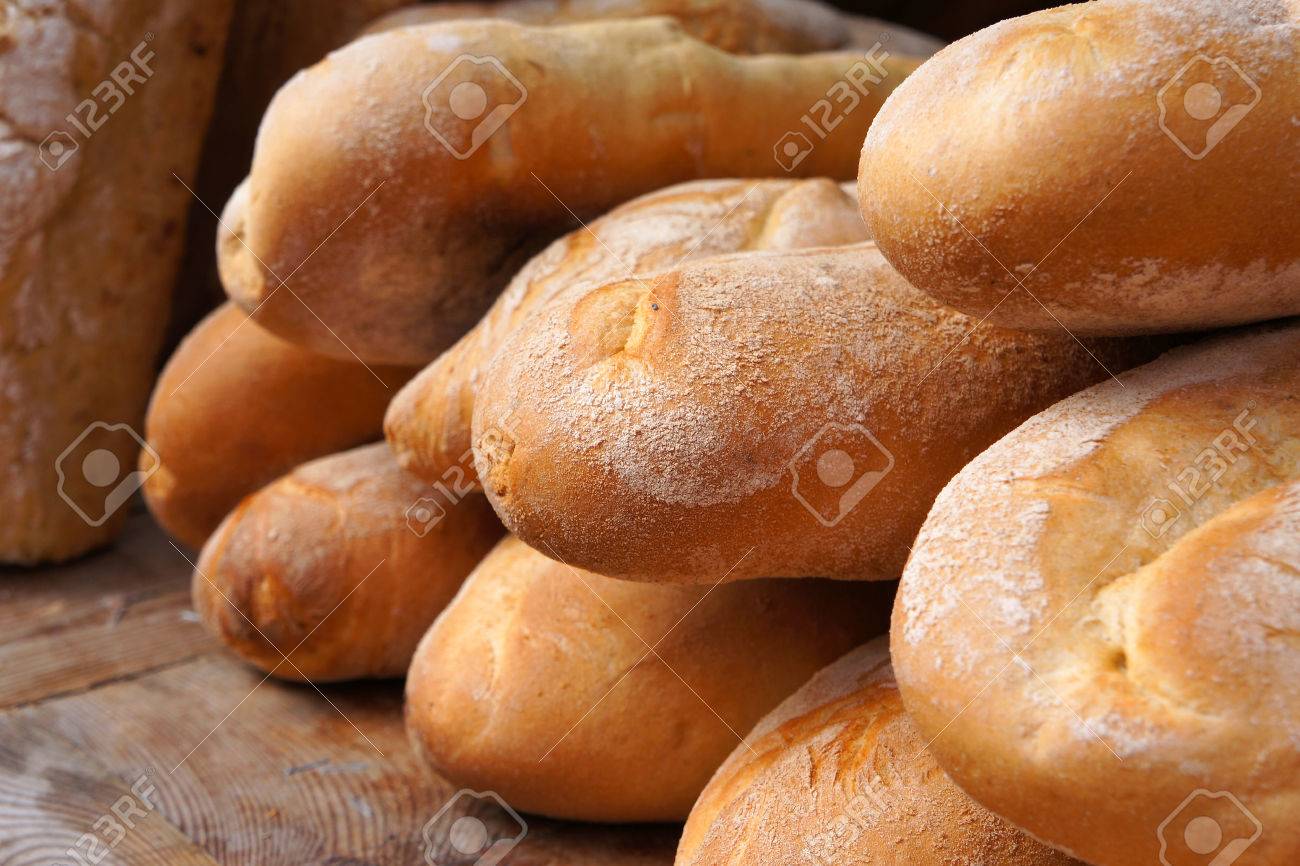 French baguettes. Wheaten long loafs. Traditional baked white bread. - 48598614 French baguettes. Wheaten long loafs. Traditional baked white bread. - 48598614