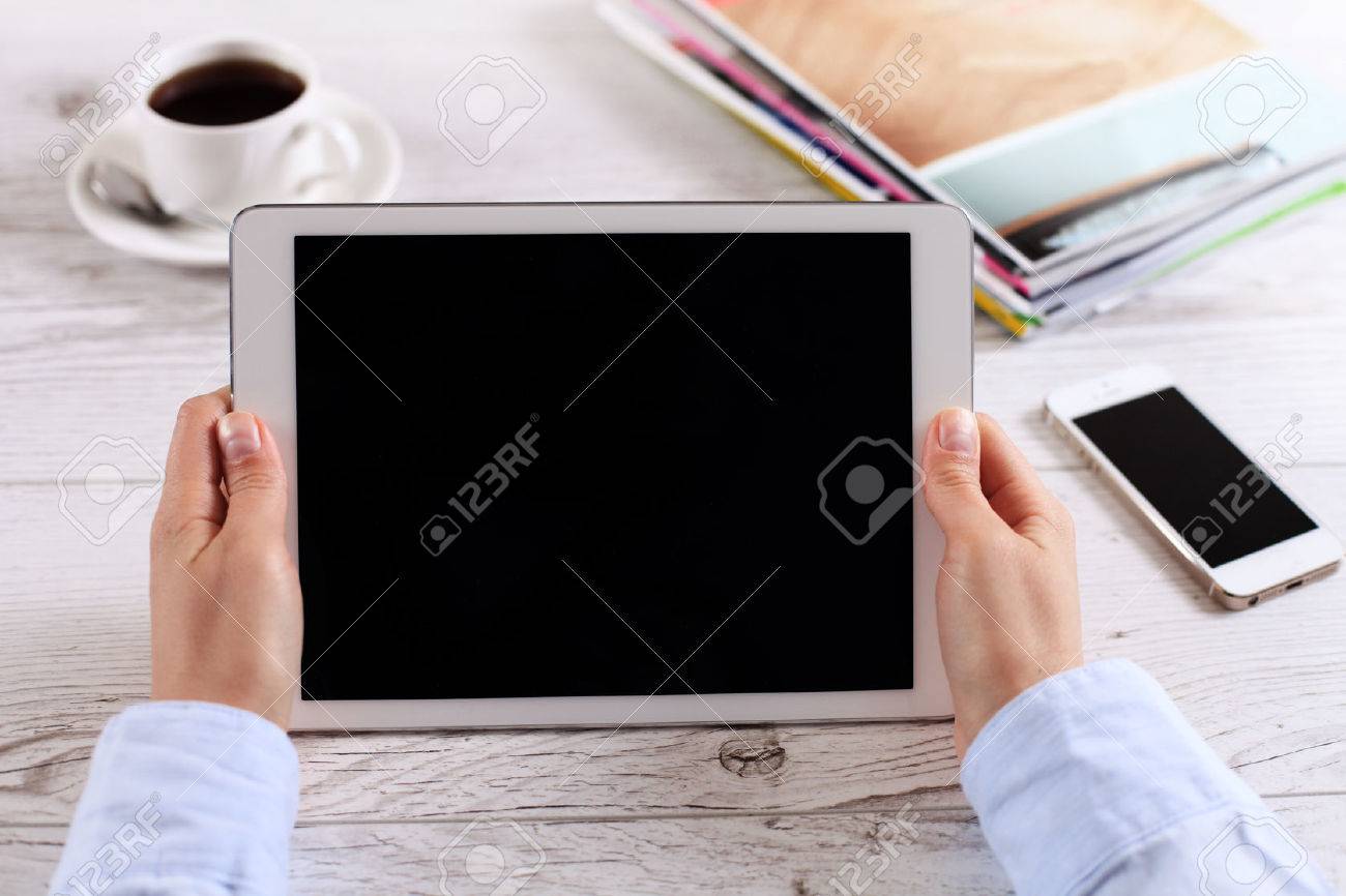 Digital tablet computer with isolated screen in female hands over cafe background - 39028497 Digital tablet computer with isolated screen in female hands over cafe background - 39028497