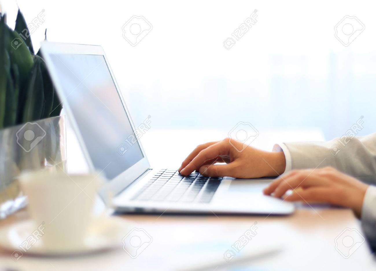 Hands of an executive working on his laptop at the office - 46580941 Hands of an executive working on his laptop at the office - 46580941