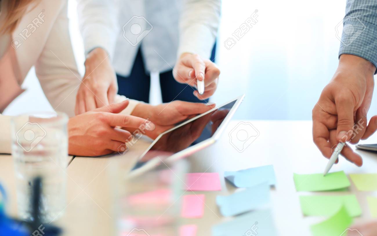 Coworkers discussing the financial status of their business on a digital tablet - 46591727 Coworkers discussing the financial status of their business on a digital tablet - 46591727
