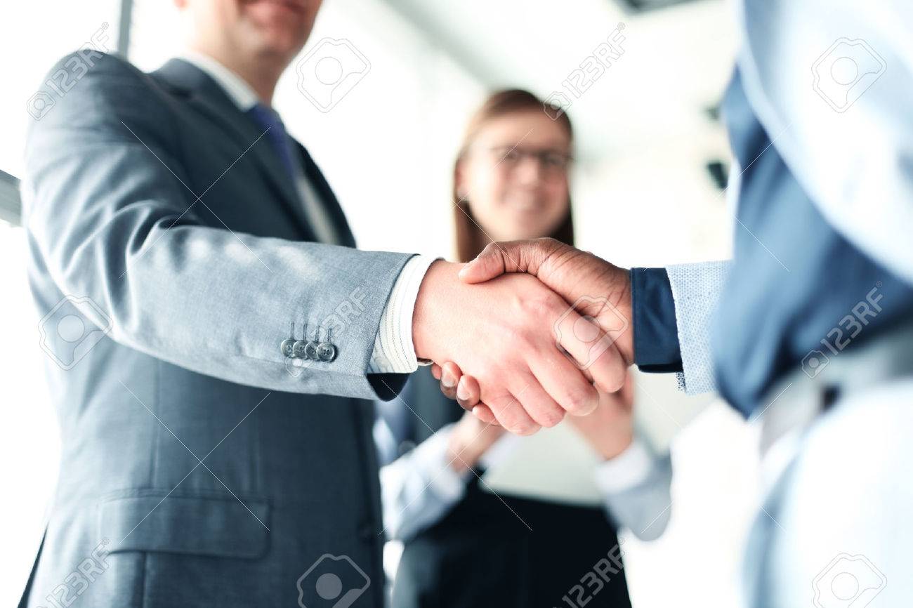 Business people shaking hands, finishing up a meeting - 56732738 Business people shaking hands, finishing up a meeting - 56732738