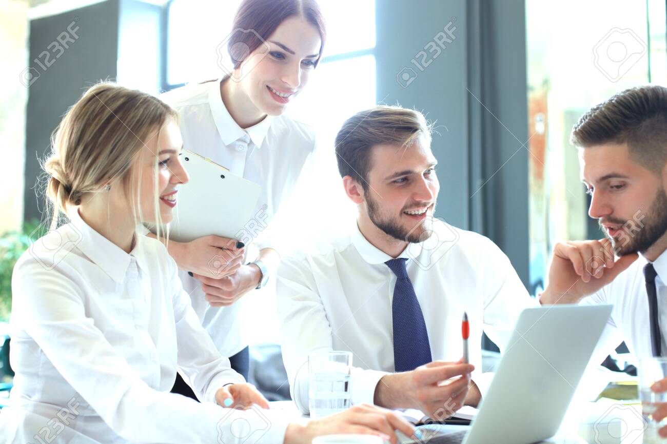 Group of business partners discussing ideas and planning work in office - 121942345 Group of business partners discussing ideas and planning work in office - 121942345