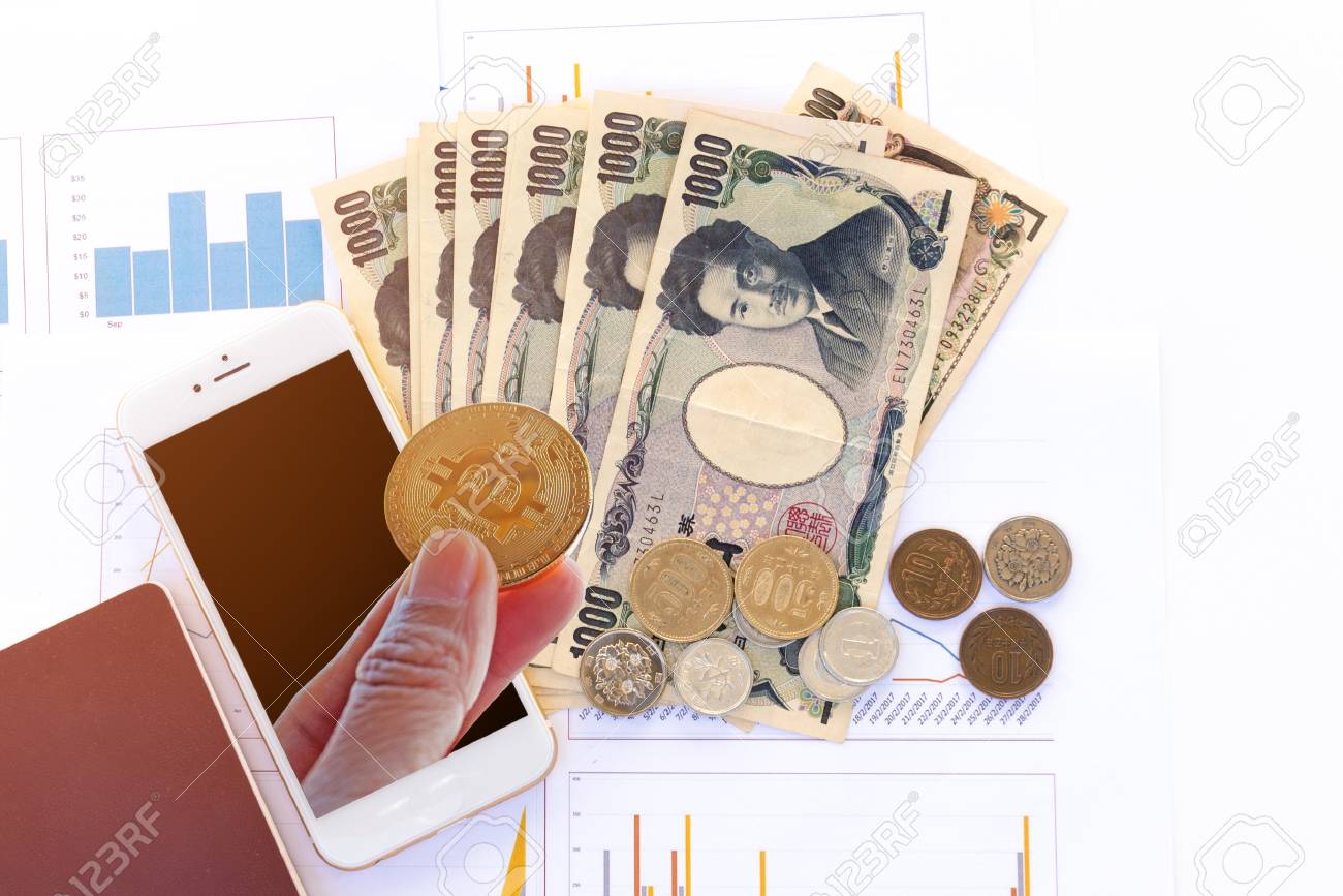 Crypto Currency Concept, Bitcoin In Hand With Japanese Currency Yen Bank  Notes, Yen Coin, Phone And Passport On Business Graph Data Background.  Stock Photo, Picture and Royalty Free Image. Image 97798314.