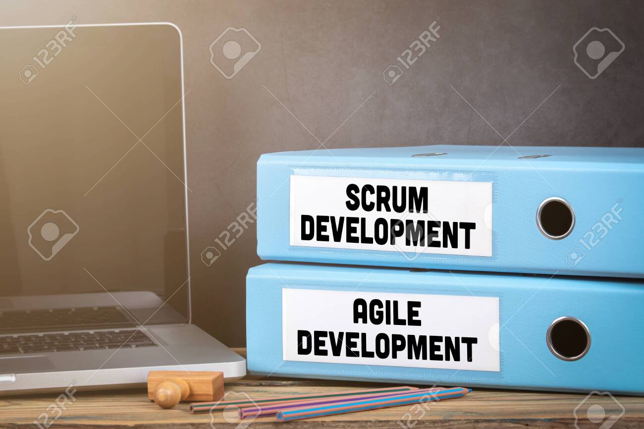scrum and agile development binders on desk in the office office binders