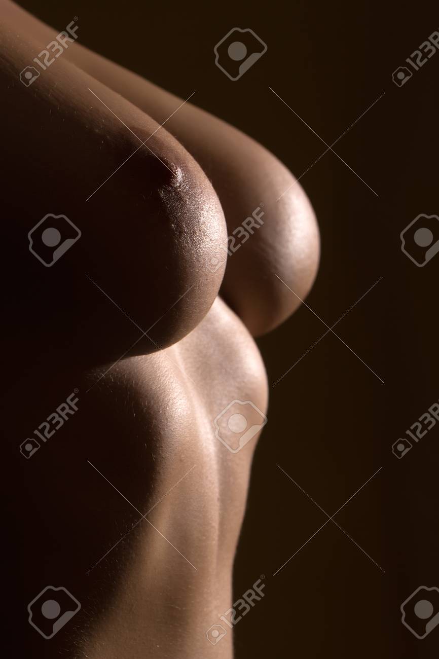 Closeup View Of Beautiful Sexy Female Bare Chest With Nipple And Soft Skin  Of Young Woman Topless With Straight Body In Studio On Yellow Background,  Vertical Picture Фотография, картинки, изображения и сток-фотография