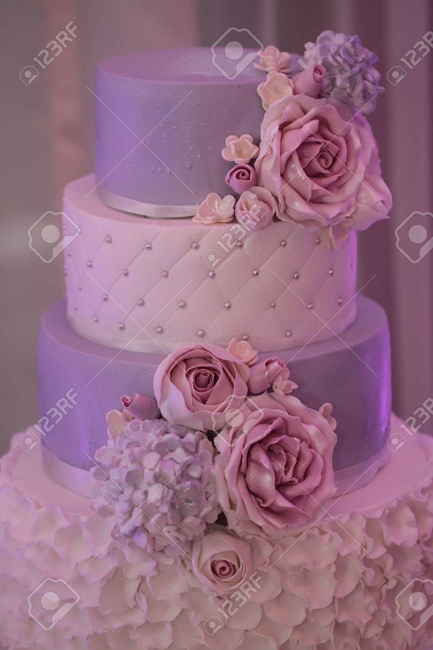 Photo Closeup Of Traditional Elegant Delicious Sweet Four Layer Wedding Cake Decorated With Butter Cream Roses On Blurred Violet Background Vertical Picture Stock Photo Picture And Royalty Free Image Image Photo Closeup Of Traditional Elegant Delicious Sweet Four Layer Wedding Cake Decorated With Butter Cream Roses On Blurred Violet Background Vertical Picture Stock Photo Picture And Royalty Free Image Image