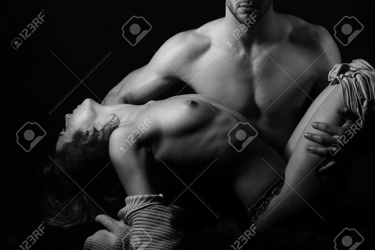 Handsome naked man is holding beautiful woman.