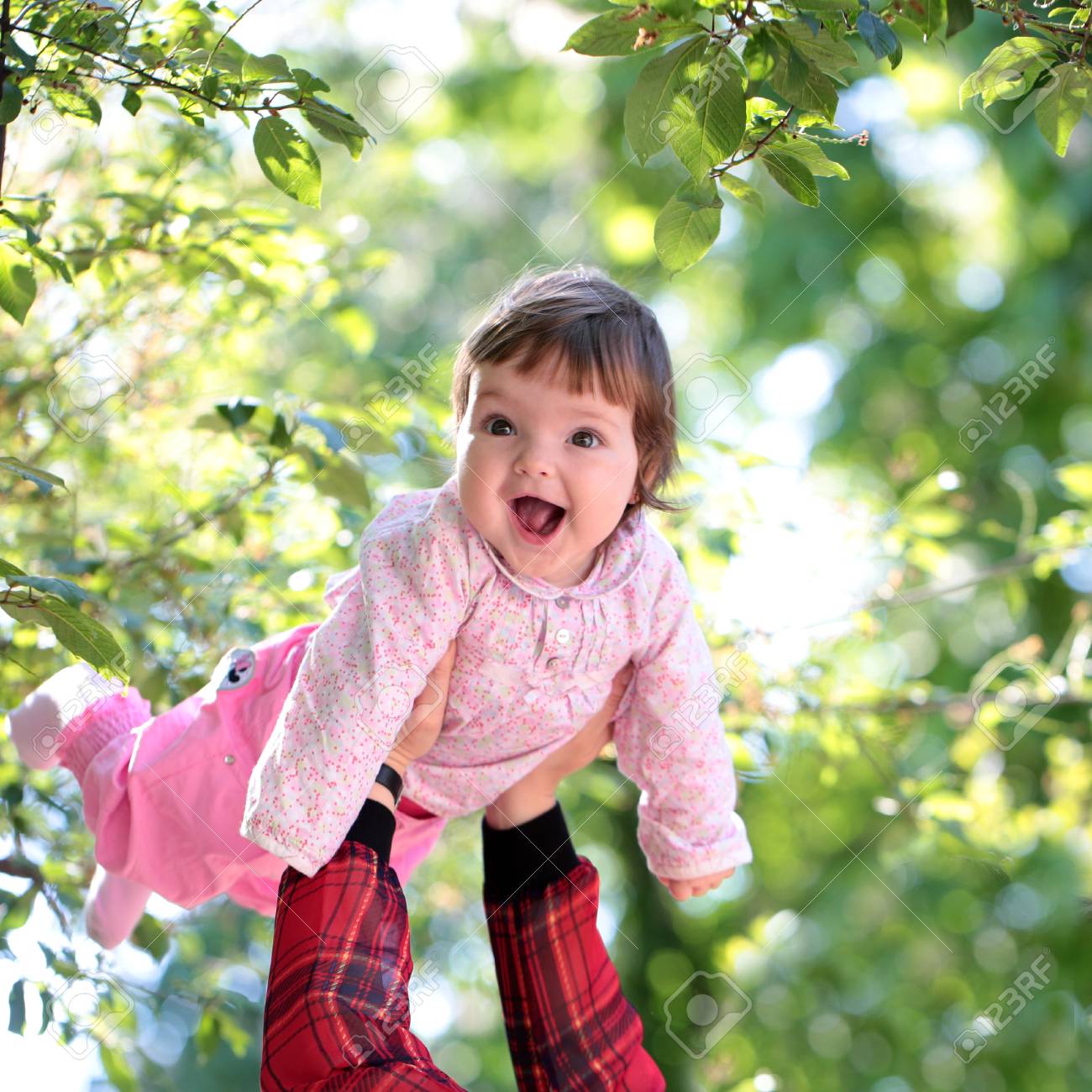 small cute baby girl with pretty smiling face and funny eyes stock
