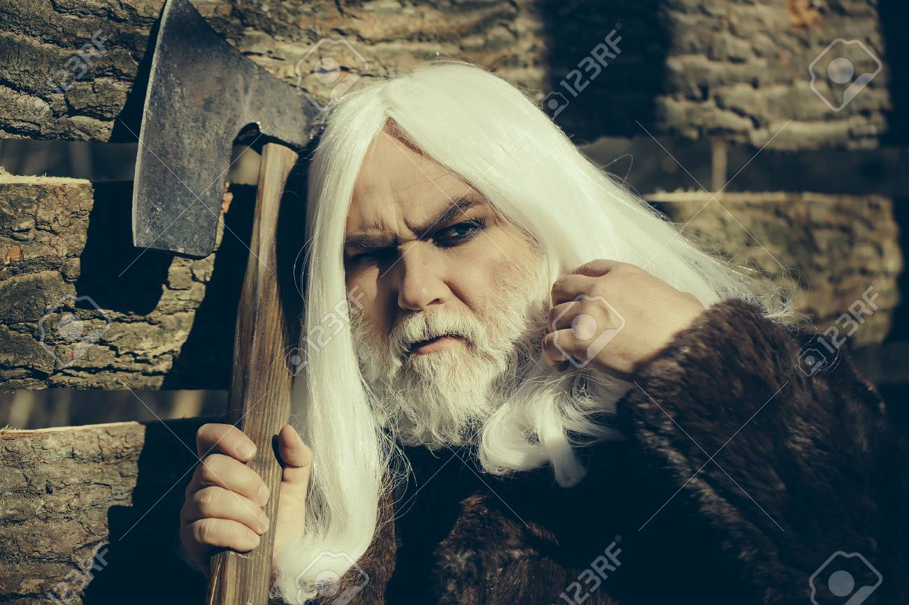 Old Man Druid With Long Silver Hair And Beard In Fur Coat Holding