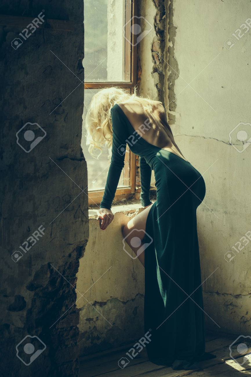 Jeune Femme Avec Les Cheveux Blonds Habillee En Robe De Sexi Vert Avec Dos Nu Posant Pres De La Vieille Fenetre Interieure Banque D Images Et Photos Libres De Droits Image 60260738