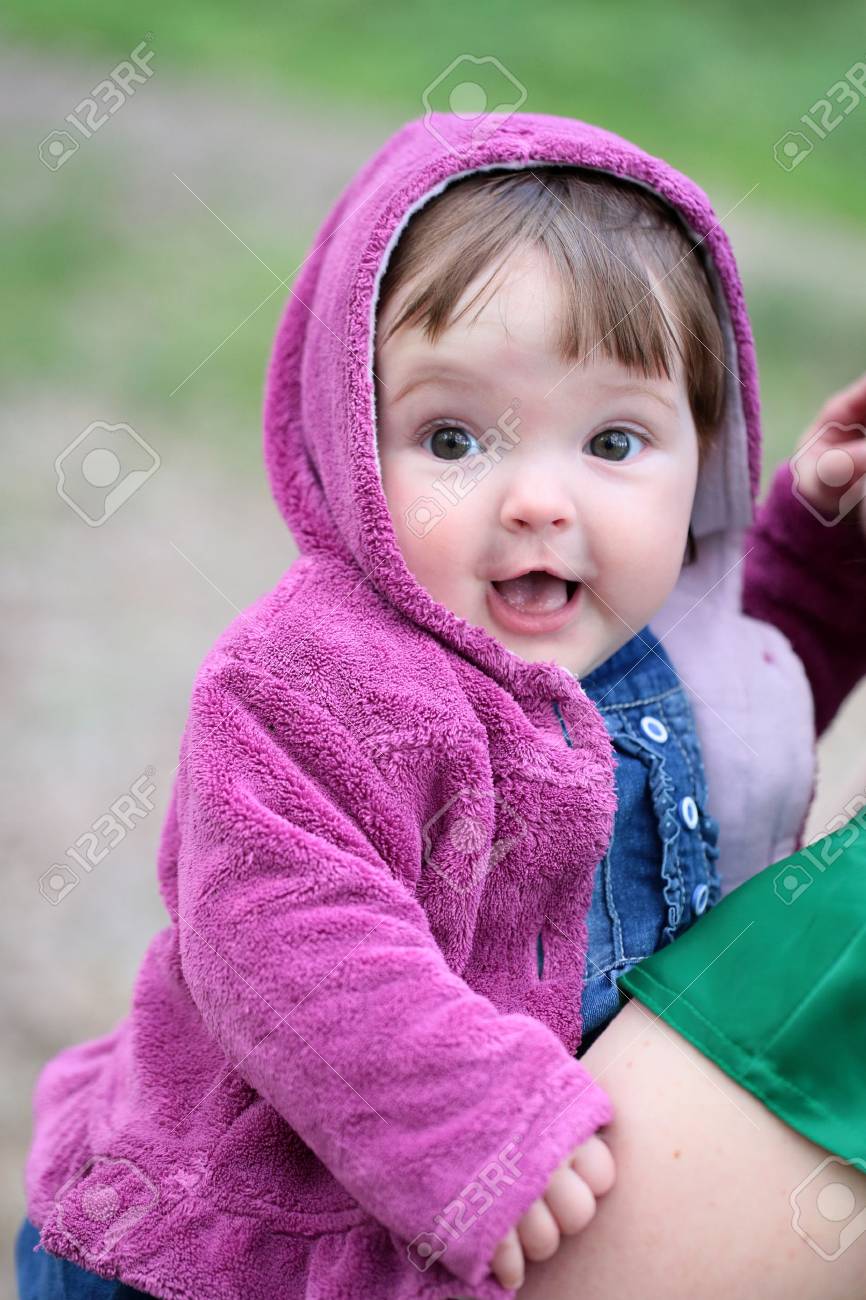 small cute baby girl with pretty smiling face and funny eyes stock