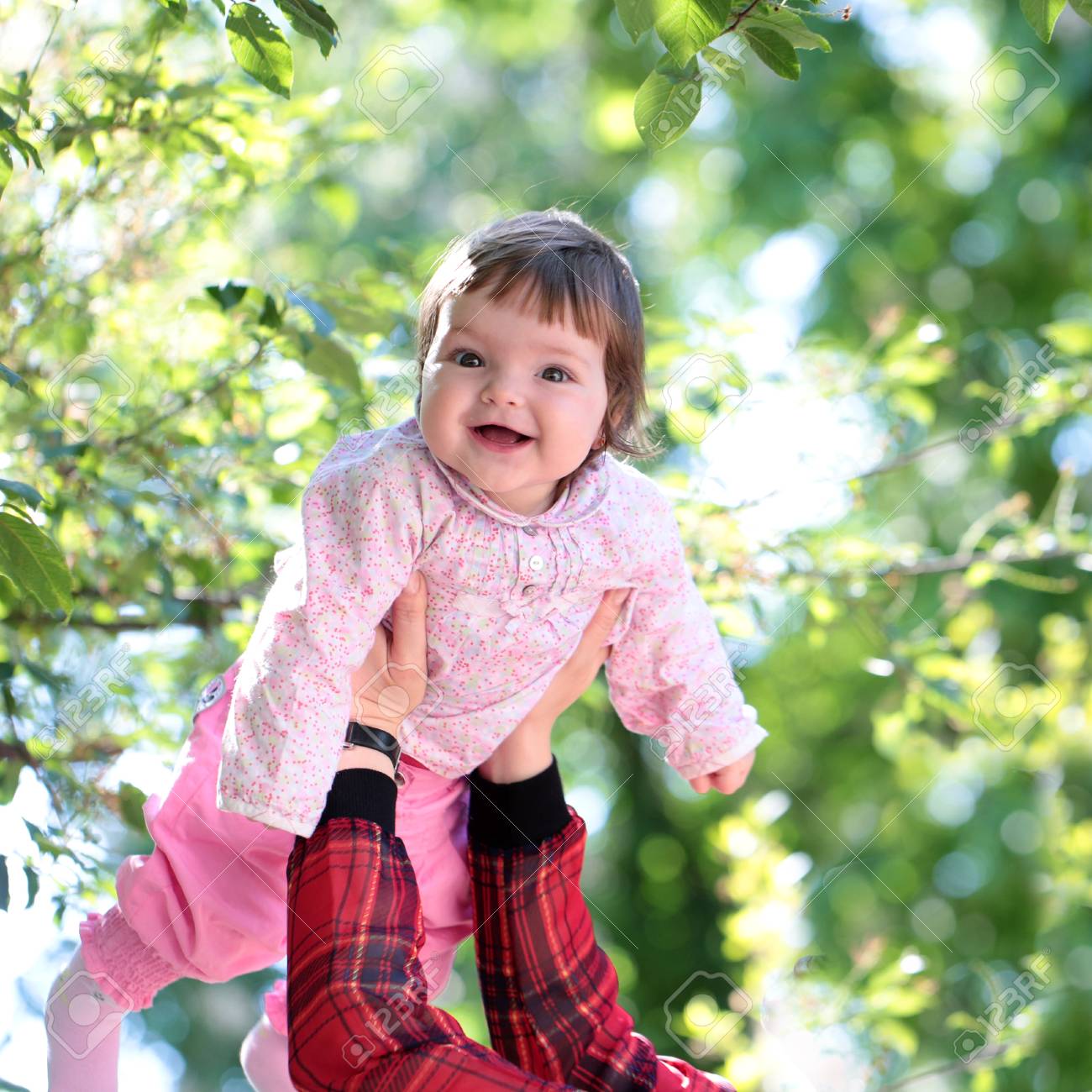 small cute baby girl with pretty smiling face and funny eyes stock