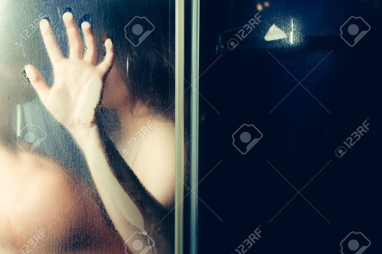 Man and woman behind the glass in the shower - 62480691 Man and woman behind the glass in the shower - 62480691