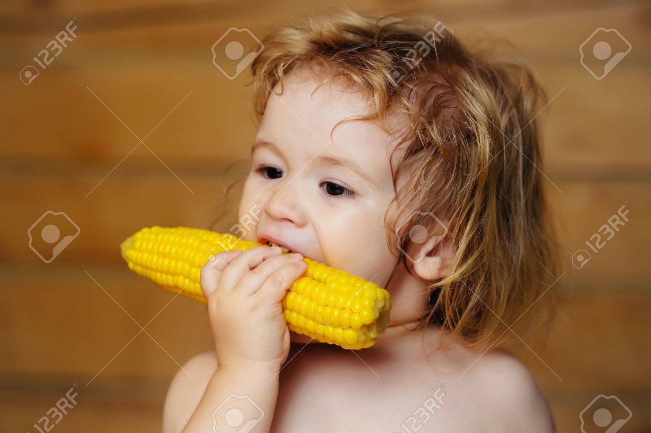 Small Boy Child With Long Blonde Hair Eating Yellow Corn Or Maize Stock Photo Picture And Royalty Free Image Image 62781130